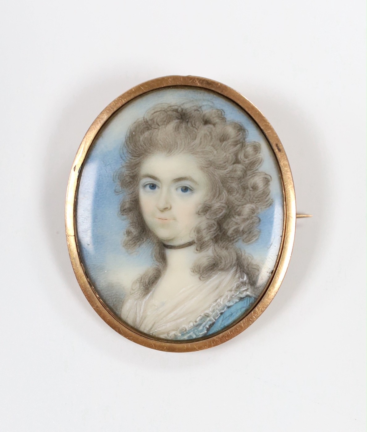 An oval portrait of a female, on ivory